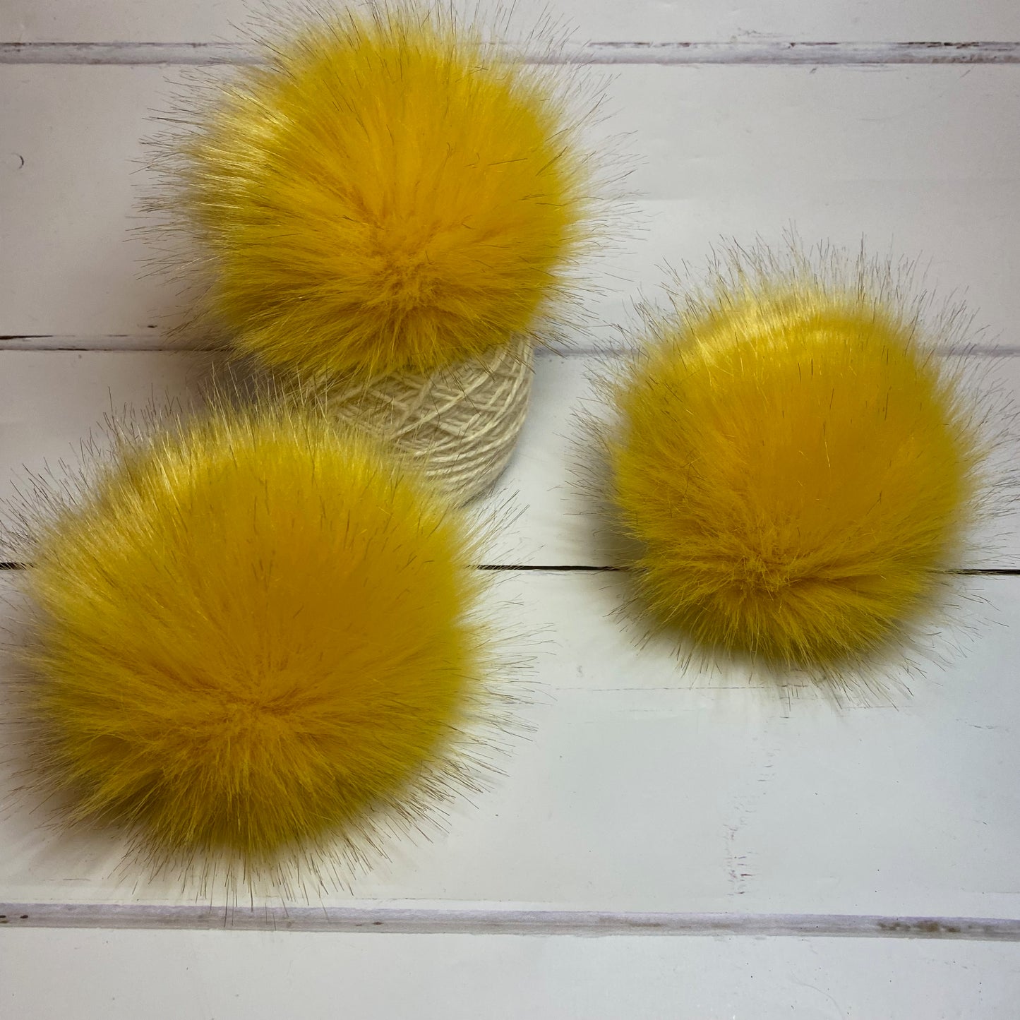 Ochre coloured faux fur pom pom. Detachable option. Handmade