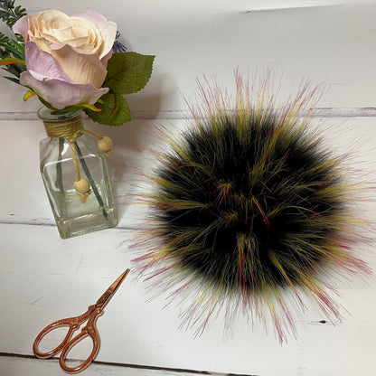 Mockingjay coloured faux fur pom pom - a black with yellow and red tips. Detachable option