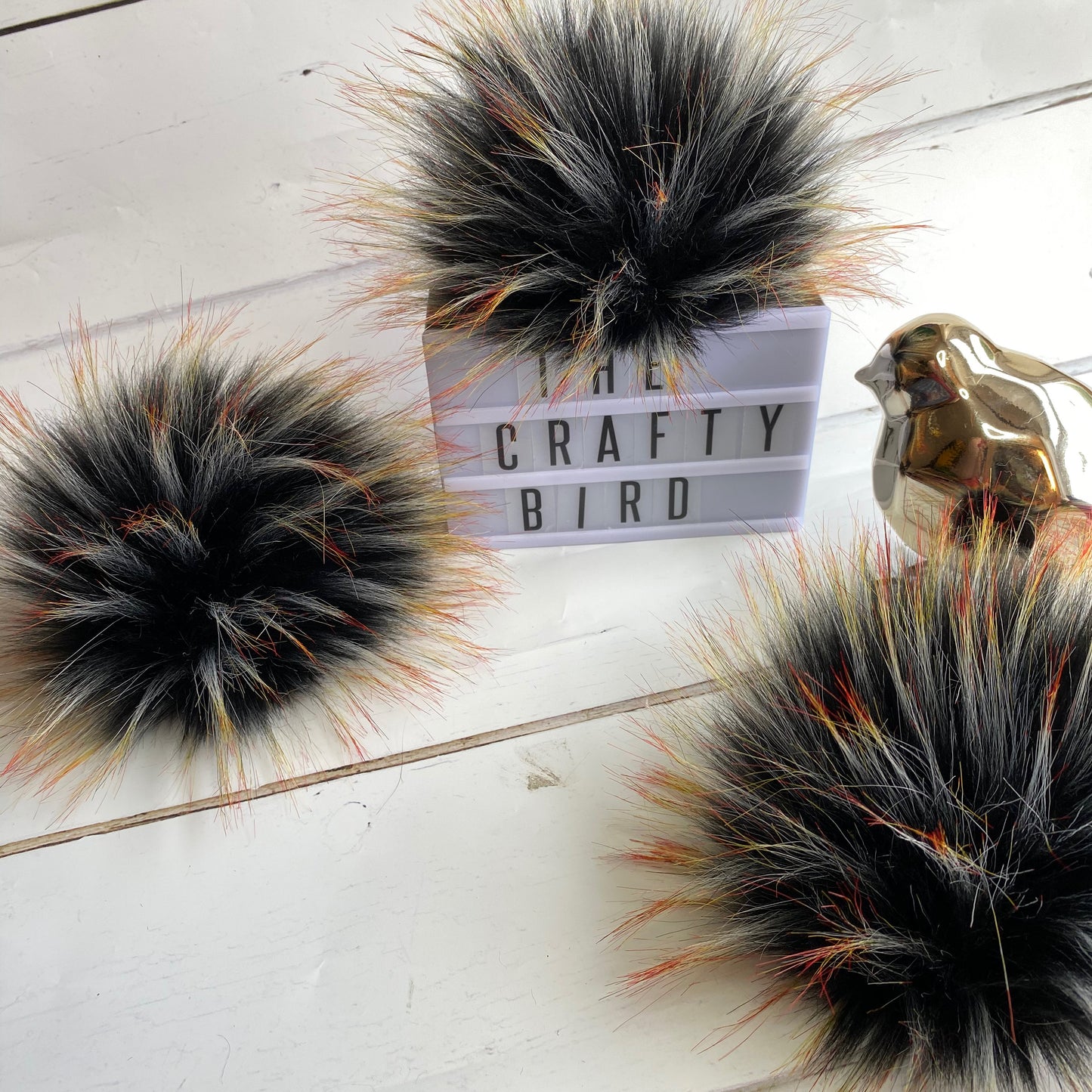 Blackbird handmade faux fur pom pom. Detachable option. Handmade